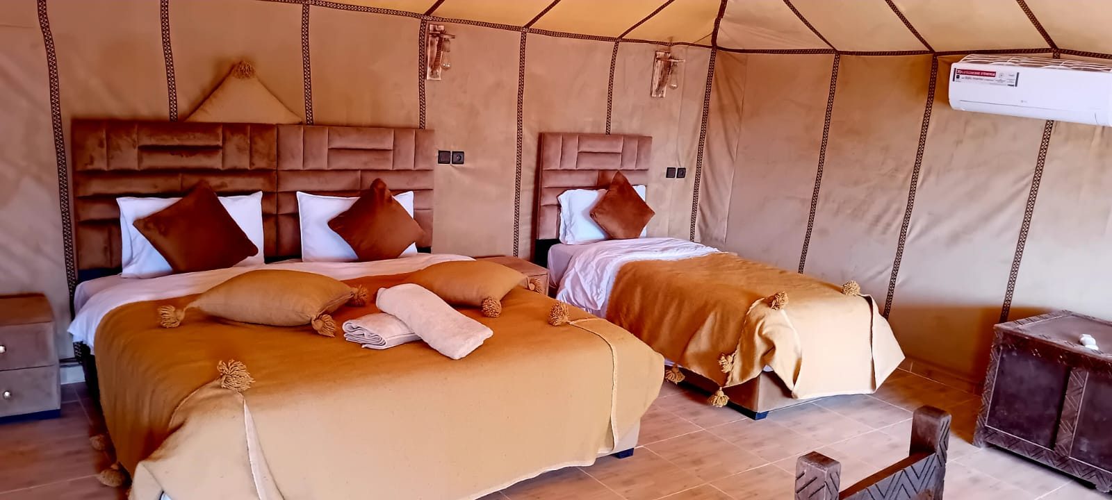 Inside a desert camp tent with warm light in Merzouga